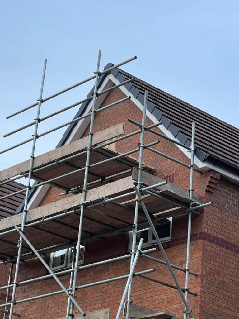 This is a photo of a roof which has just been repaired. There is a scaffold located at the gable end for access onto the roof. Works carried out by Matlock Roofing Repairs