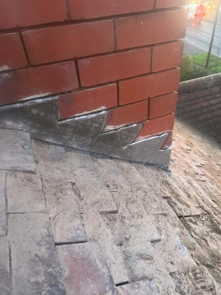 This is a photo of new leadwork being installed around an old chimney. Works carried out by Matlock Roofing Repairs