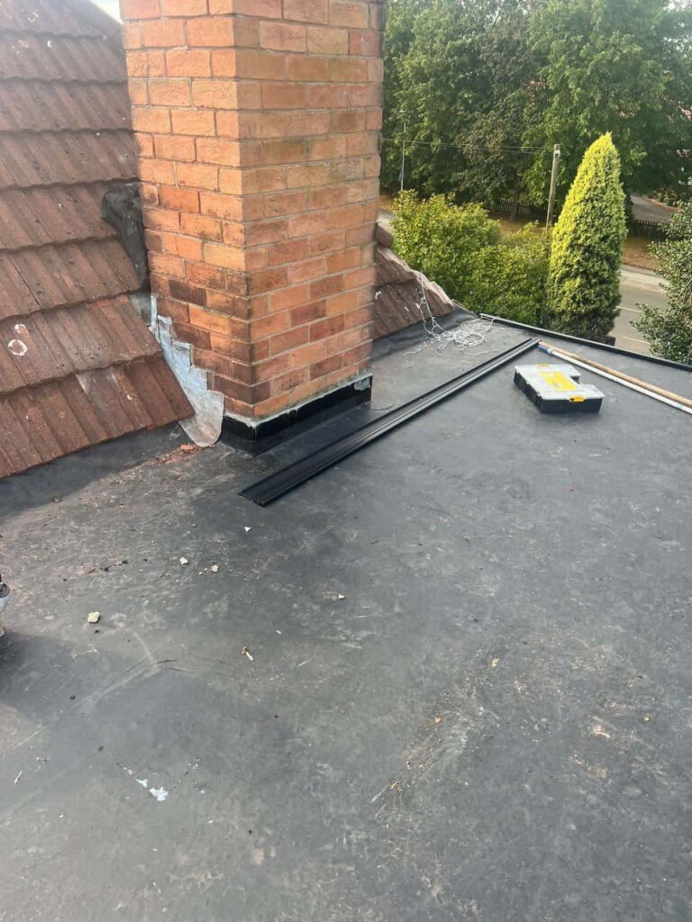 This is a photo of a flat roof which has just been repaired, there is also a chimney stack and some leadwork has also been dressed. Works carried out by Matlock Roofing Repairs